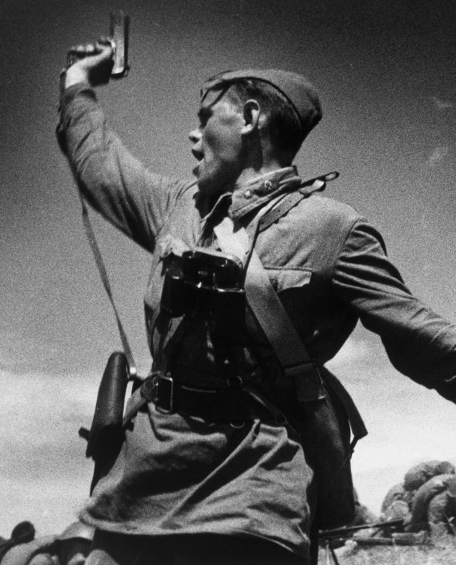 A Soviet junior political officer (Politruk) urges Soviet troops forward against German positions (12 July 1942).