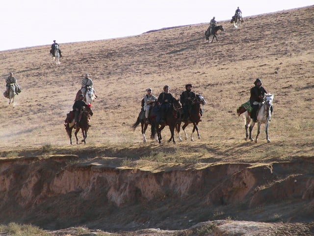 Special Forces soldiers from Task Force Dagger and Commander Dostum on horseback in the Dari-a-Souf Valley, Afghanistan, circa October 2001—featured in the film "12 Strong"