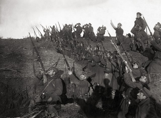 Bulgarian soldiers in a trench, preparing to fire against an incoming aeroplane