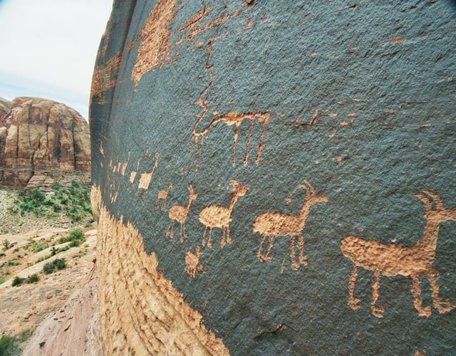 A petroglyph of a caravan of bighorn sheep near Moab, Utah, United States; a common theme in glyphs from the desert Southwest and Great Basin