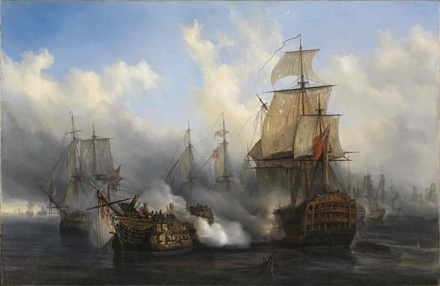 The British HMS Sandwich fires to the French flagship Bucentaure (completely dismasted) in the battle of Trafalgar. Bucentaure also fights HMS Victory (behind her) and HMS Temeraire (left side of the picture). HMS Sandwich never fought at Trafalgar and her depiction is a mistake by the painter.