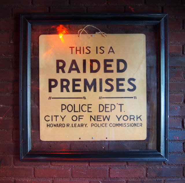 The sign left by police following the raid is now on display just inside the entrance