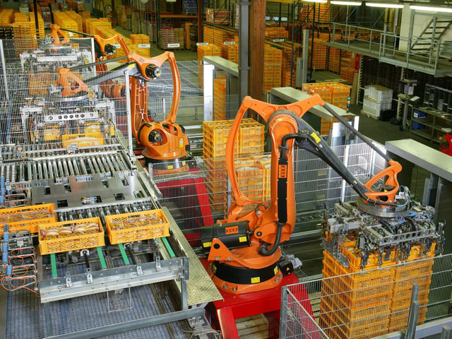 Factory Automation with industrial robots for palletizing food products like bread and toast at a bakery in Germany.