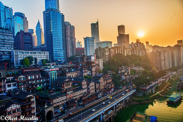 The skyscrapers of Chongqing CBD with Hongya Cave at sunset