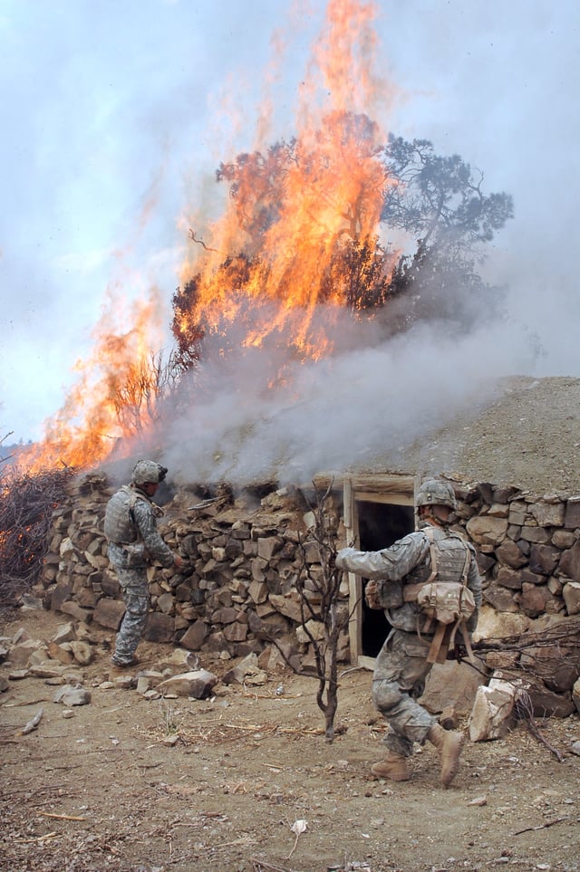 US soldiers burn a suspected Taliban safehouse.