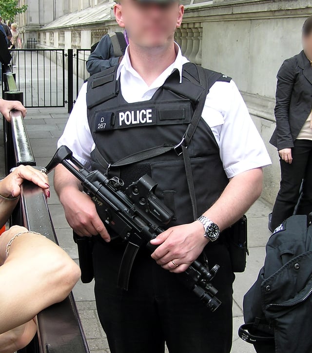 Authorised Firearms Officers standing guard at the entrance to Downing Street, London, home of the UK Prime Minister. This officer is attached to the Diplomatic Protection Group and is carrying a semi-auto MP5SFA3.
