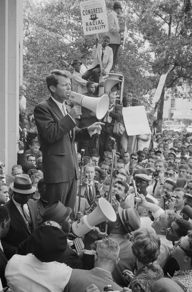 Attorney General Robert Kennedy speaking before a hostile Civil Rights crowd protesting low minority hiring in his Justice Department June 14, 1963