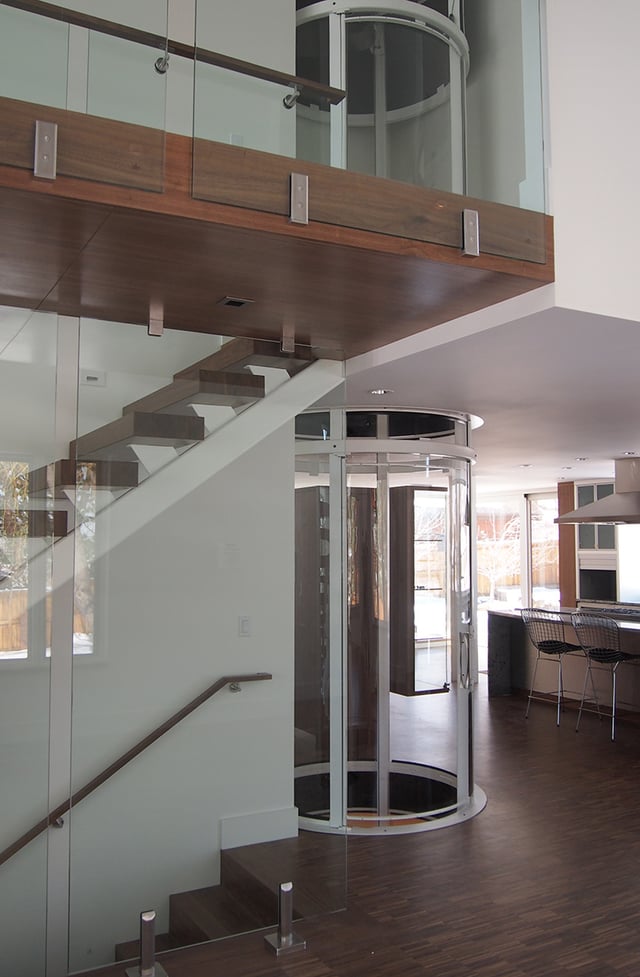 A residential elevator with integrated hoistway construction and machine-room-less design