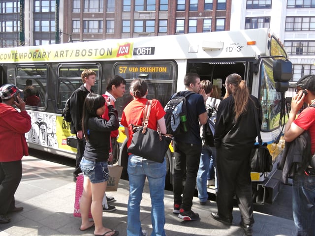 Passengers board a route 57 bus at Kenmore