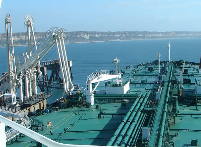 Cargo flows between a tanker and a shore station by way of marine loading arms attached at the tanker's cargo manifold.