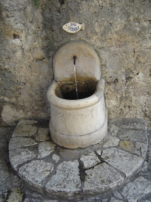 A fountain in Saint-Paul-de-Vence, France. The sign reading Eau potable indicates that the water is safe to drink.