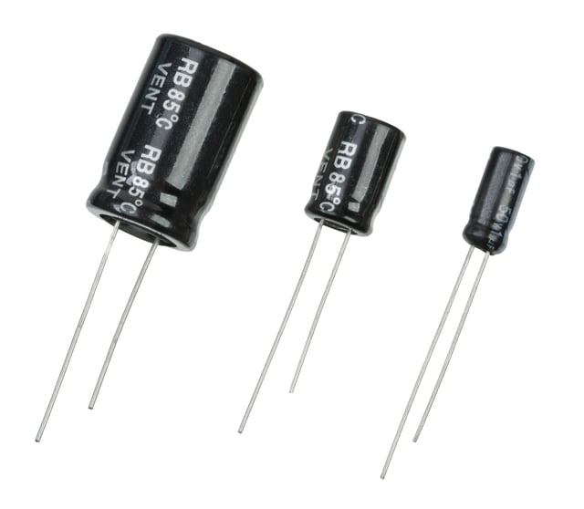 Three aluminum electrolytic capacitors of varying capacity.