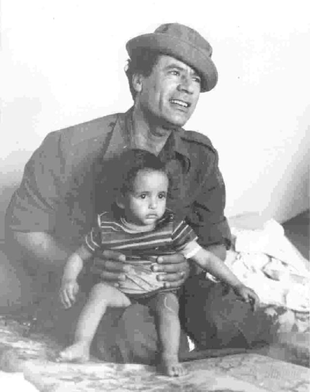 Gaddafi in 1976 with his son Saif al-Islam Gaddafi on his lap
