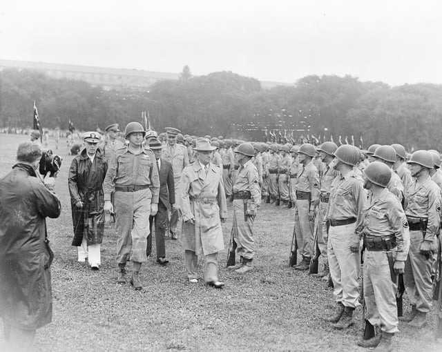 President Truman walks past members of the 442nd Regimental Combat Team as they stand at attention on the Ellipse.