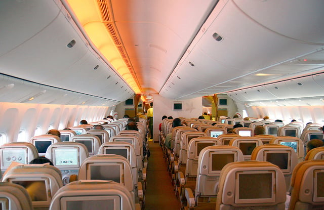Economy class cabin of an Etihad Airways 777-300ER in a 3–3–3 layout.