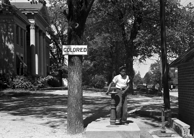An African-American youth at a segregated drinking fountain in Halifax, North Carolina, in 1938.