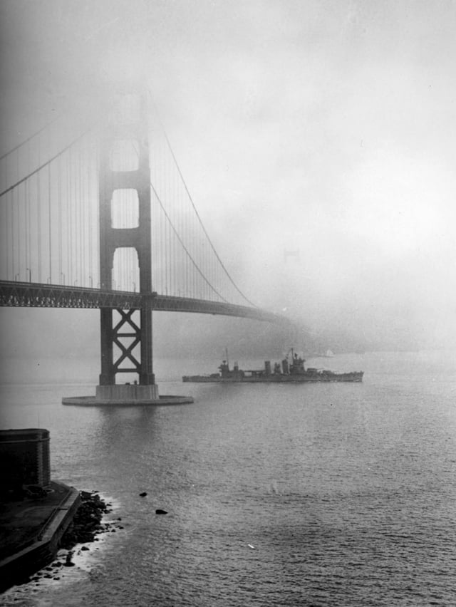 The USS San Francisco steams under the Golden Gate Bridge in 1942, during World War II.