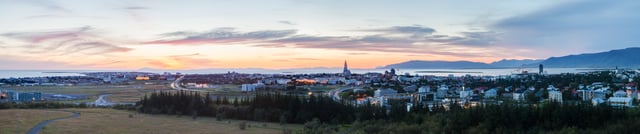Panorama of Reykjavík seen from Perlan at sunset in summer. As seen in the picture, Reykjavík is mild enough for trees to grow.