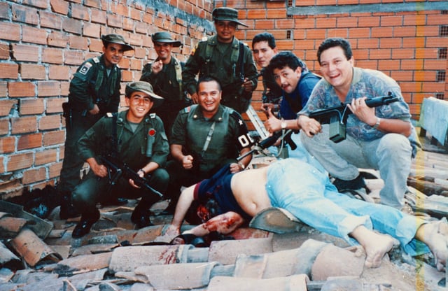 Members of Colonel Martinez's Search Bloc celebrate over Pablo Escobar's body on December 2, 1993
