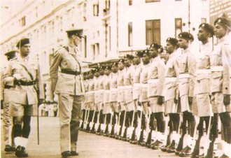 Brigadier James Sinclair, Earl of Caithness inspecting a guard of honour wearing khaki drill
