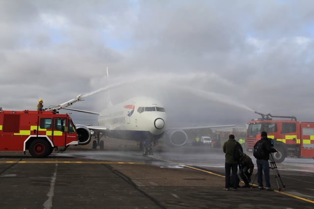 Boeing 737-400 G-DOCB, formerly operated by British Airways, receives a water salute after landing at Cranfield University for preservation.