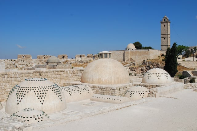 Aleppo Citadel, roof of the baths, with the mosque and minaret in the background.
