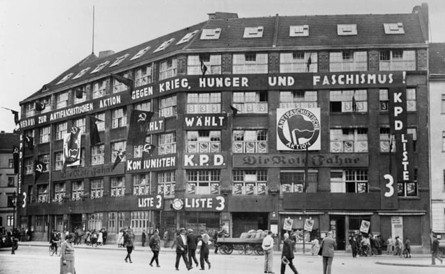 Karl-Liebknecht-Haus, the KPD's headquarters from 1926 to 1933. The Antifaschistische Aktion (a.k.a. "Antifa") logo can be seen prominently displayed on the front of the building. The KPD leaders were arrested by the Gestapo in this building in January 1933, when Hitler became Chancellor. The plaques on either side of the door recall the building's history. Today it is the Berlin headquarters of the Left Party.