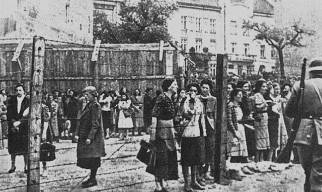 Women behind the barbed wire fence of the Lvov Ghetto in occupied Poland. Spring 1942