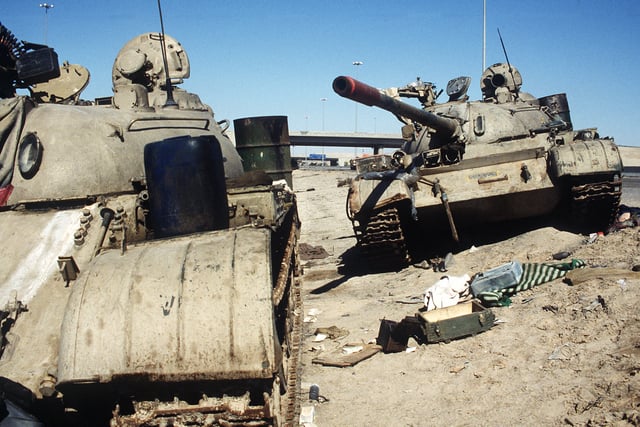 Two Iraqi tanks lie abandoned near Kuwait City on 26 February 1991.
