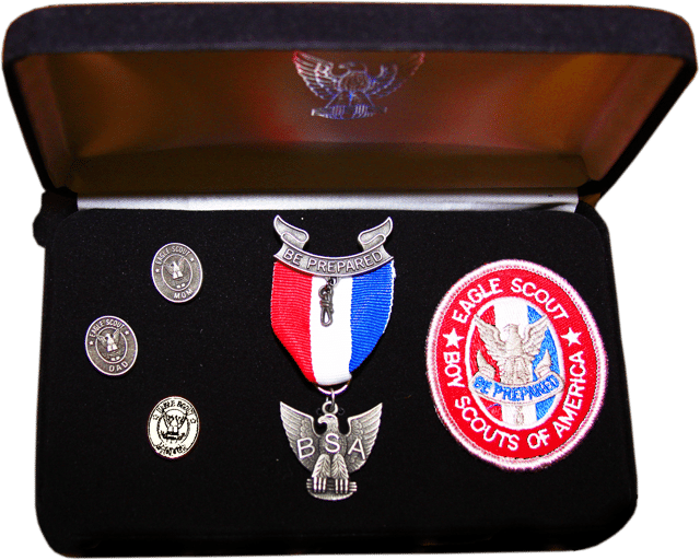 An Eagle Scout presentation kit, including: Mother's oval pin, Dad's oval pin, Mentor oval pin, Eagle badge, and Eagle award medal