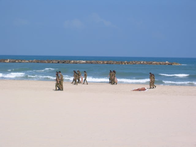 IDF soldiers cleaning the beaches at Tel Aviv, which have scored highly in environmental tests.