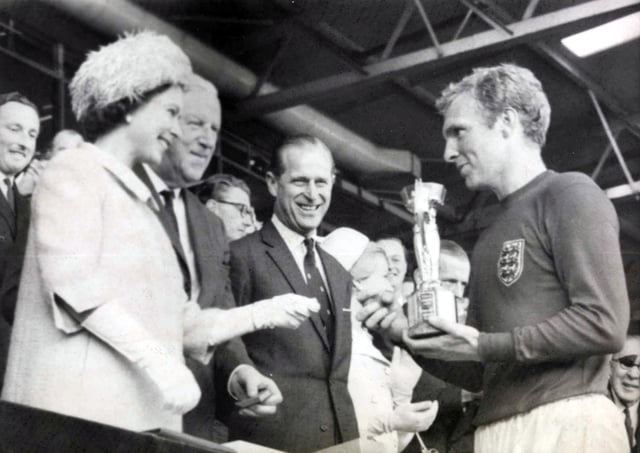 Queen Elizabeth II presenting the World Cup trophy to 1966 World Cup winning England captain Bobby Moore