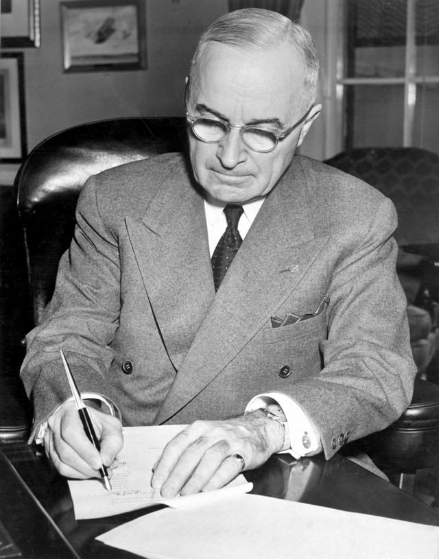 President Truman signing a proclamation declaring a national emergency and authorizing U.S. entry into the Korean War
