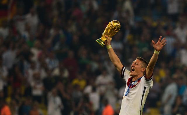Schweinsteiger celebrates with the World Cup trophy after winning the 2014 FIFA World Cup Final.