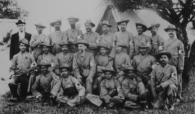 Stretcher-bearers of the Indian Ambulance Corps during the war, including the future leader Mohandas Karamchand Gandhi (Middle row, 5th from left).