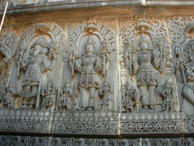An art depiction of the Trimurti, with Shiva depicted on the right, at the Hoysaleswara temple in Halebidu.
