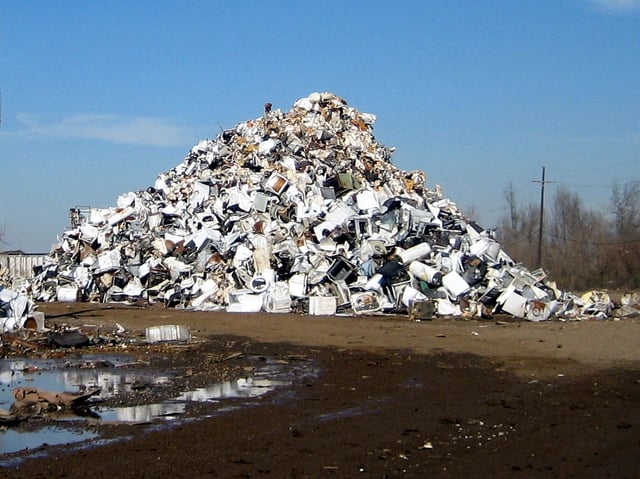 New Orleans after Hurricane Katrina: mounds of trashed appliances with a few smashed automobiles mixed in, waiting to be scrapped