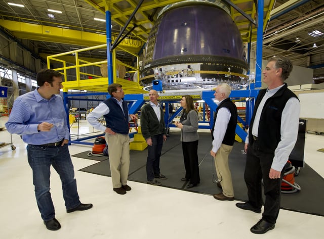 Bezos giving NASA Deputy Administrator Lori Garver (fourth from left) a tour of Blue Origin's crew capsule in 2011.