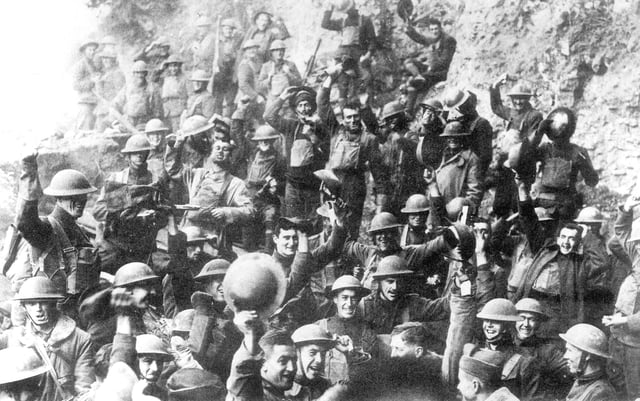 Men of US 64th Regiment, 7th Infantry Division, celebrate the news of the Armistice, 11 November 1918