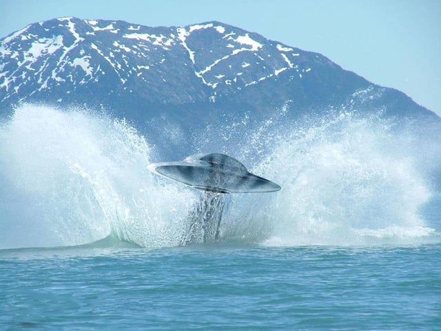 A typical shape of a unidentified flying object commonly known as a flying saucer, exiting from a water surface.