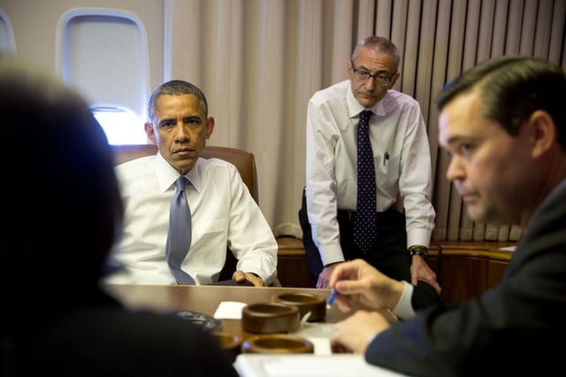 President Obama holds a meeting with John Podesta and Susan Rice aboard Air Force One, 2015