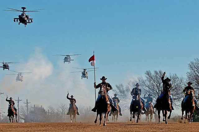 The 1st Cavalry Division's combat aviation brigade performs a mock charge with the horse detachment