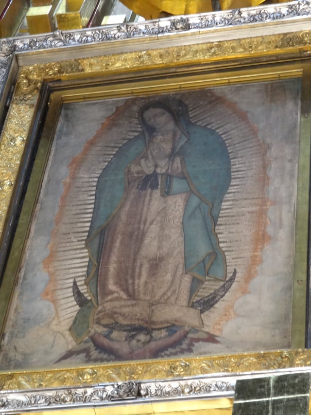 Our Lady of Guadalupe, patron saint of Mexico, an ancient Marian title of Amerindian race. This painting of her at the Basilica of Guadalupe is among her most notable depictions; scientists still debate if it should be dated 1531, the year of the first apparition, or the 1550s.