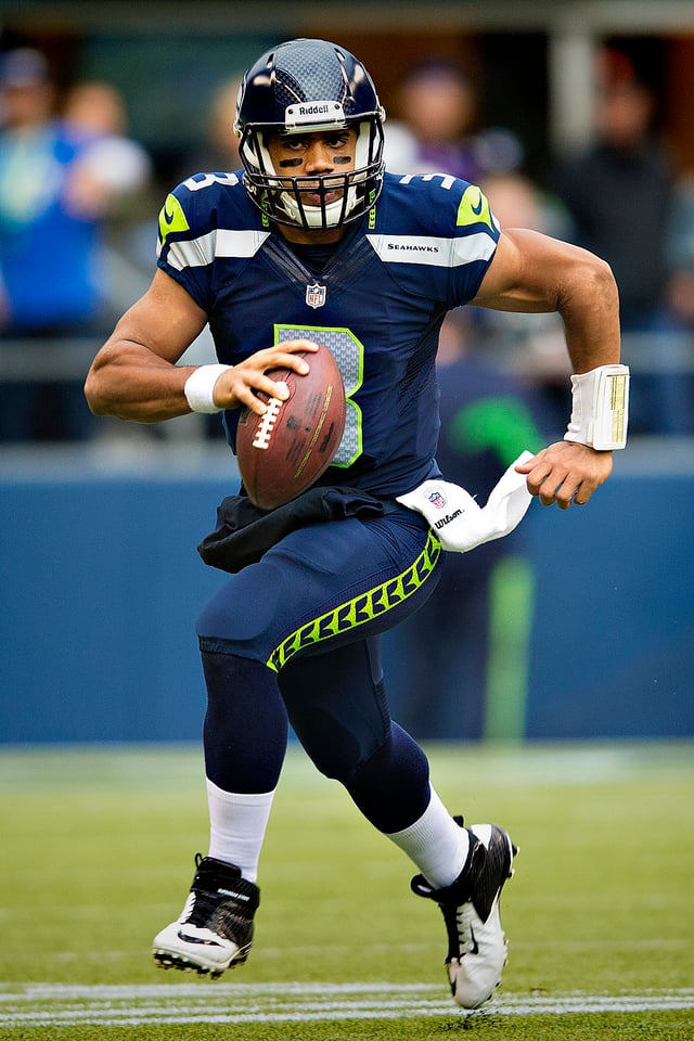 Russell Wilson wearing the current Seahawks home uniform.
