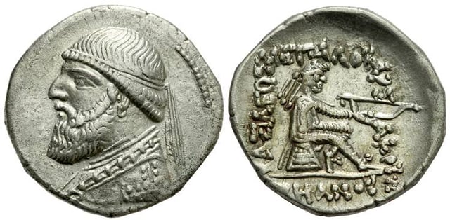 Coin of Mithridates II of Parthia. The clothing is Parthian, while the style is Hellenistic (sitting on an omphalos). The Greek inscription reads "King Arsaces, the philhellene"