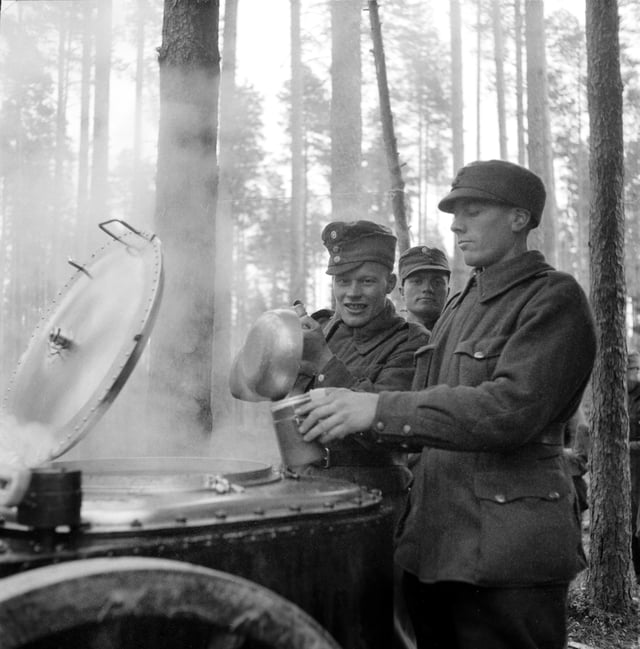 Finnish soldiers gathering breakfast from a field kitchen during "additional refresher training" at the Karelian Isthmus on 10 October 1939