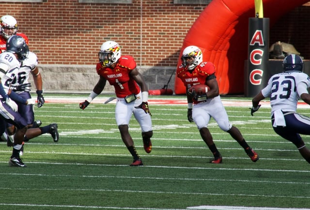 Stefon Diggs, left, prepares to lead block for Terps running back Brandon Ross