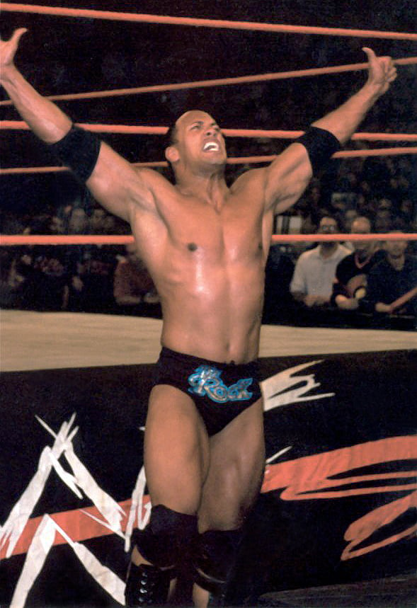 The Rock taunting an opponent at ringside