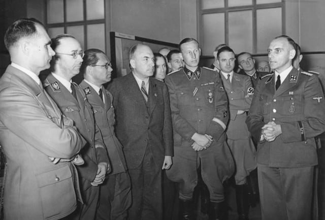 Rudolf Hess, Himmler, Phillip Bouhler, Fritz Todt, Reinhard Heydrich, and others listening to Konrad Meyer at a Generalplan Ost exhibition, 20 March 1941