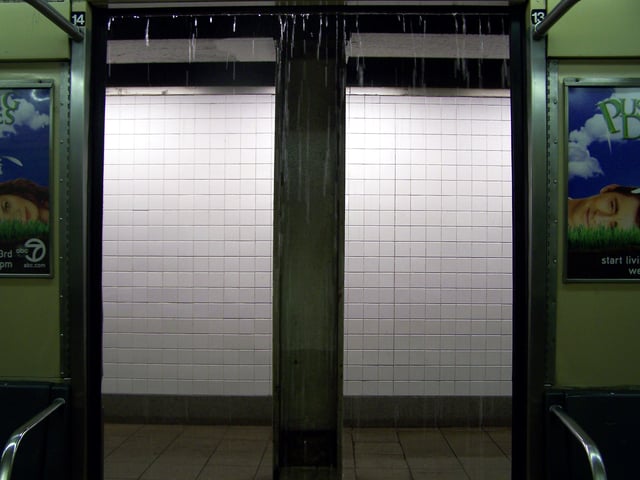 Rain from drainage pipes comes into a subway car